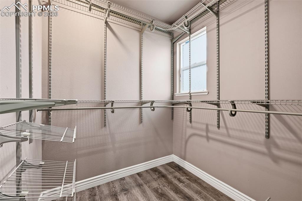 Image 26 of 50: A generous walk in closet with organizers will make short order of organizi