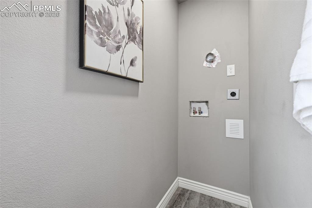 Image 27 of 50: Hookups for a washer & dryer in the primary bathroom make laundry day easie