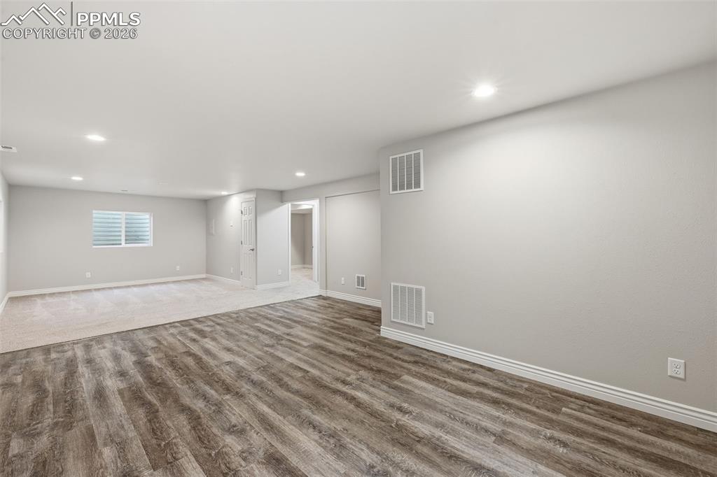 Image 33 of 50: You could have an exercise area or playroom in this basement area.