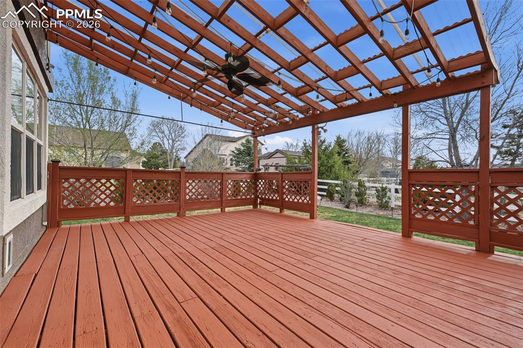 Image 36 of 50: A covered deck with a ceiling fan! Even party lights already for your next