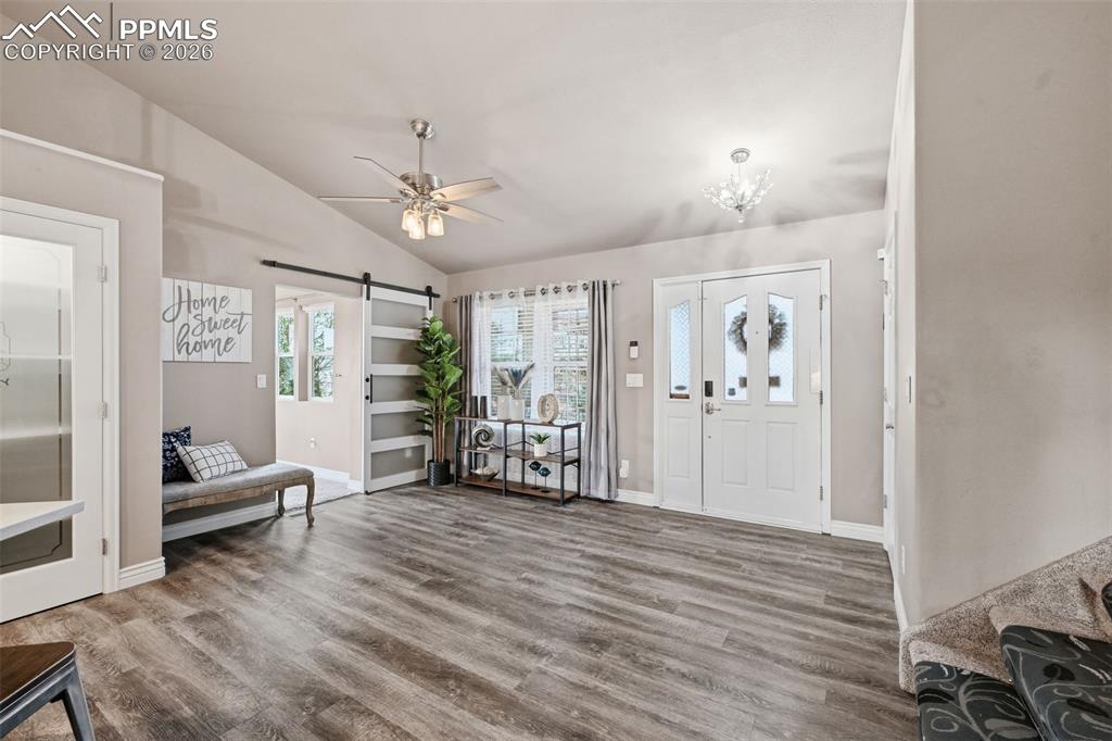 Image 4 of 50: The entryway at the front door. This shows the entry to the sunroom with a