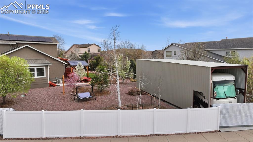 Image 43 of 50: A view of the yard with a vinyl privacy fence. No maintenance.