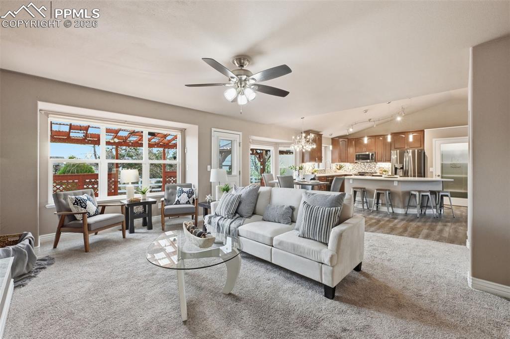 Image 8 of 50: As you look from the family room into the dining room and kitchen, there is