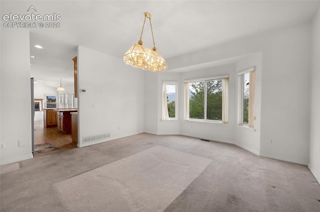 Image 11 of 48: Dining Room Featuring a Bay Window with Awesome Mountain Views