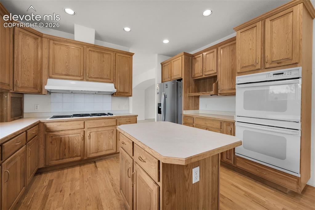 Image 14 of 48: Kitchen Showing Island, Double Oven and Gas Range