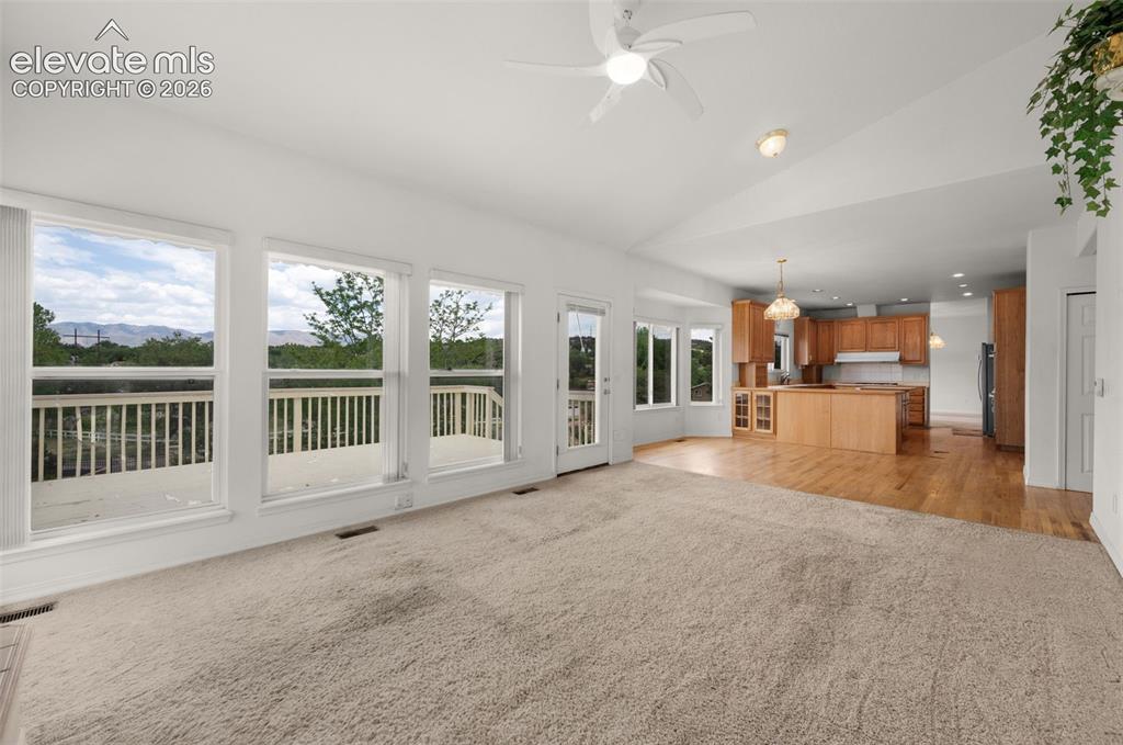 Image 17 of 48: Family Room Looking on to Breakfast Nook and Kitchen and Walk-out to the De