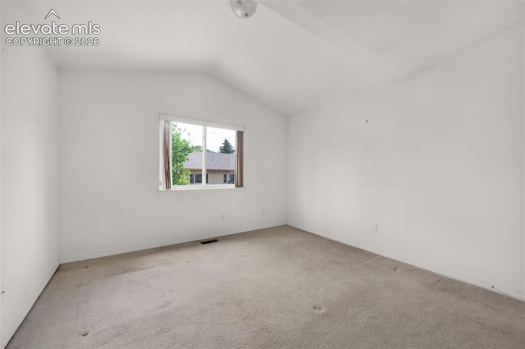 Image 31 of 48: Third Upstairs Bedroom with Vaulted Ceilings and Walk-in Closet