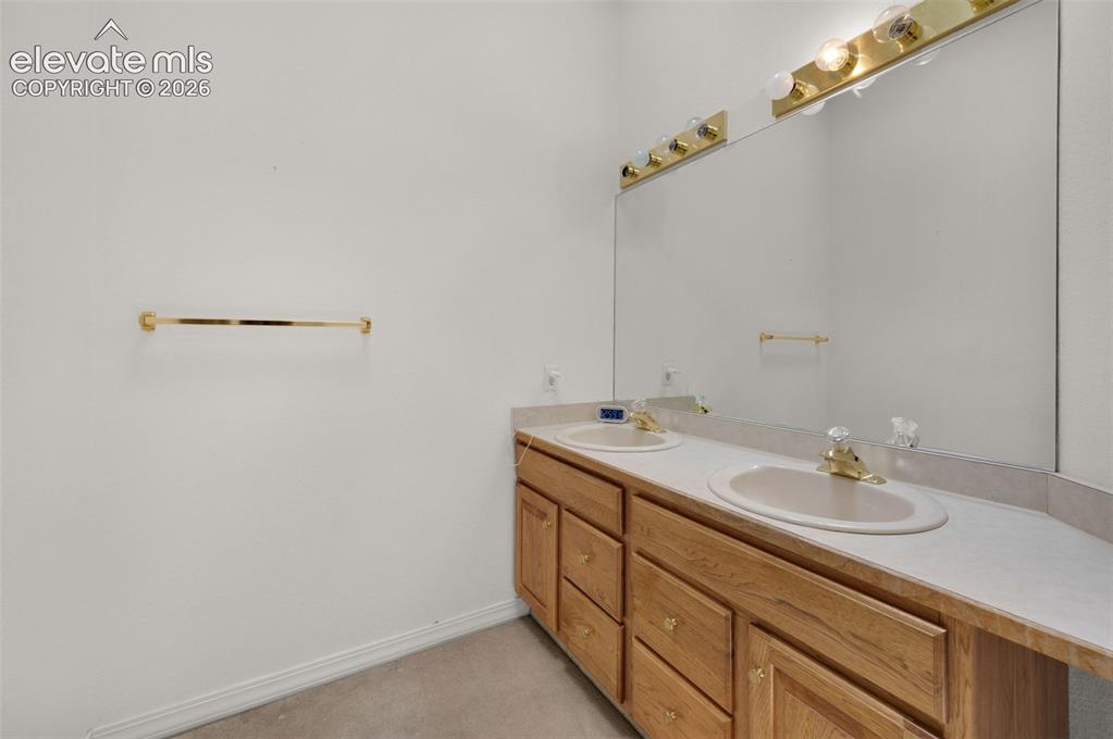 Image 32 of 48: Upstairs Full Bath with Double Vanity and Skylight