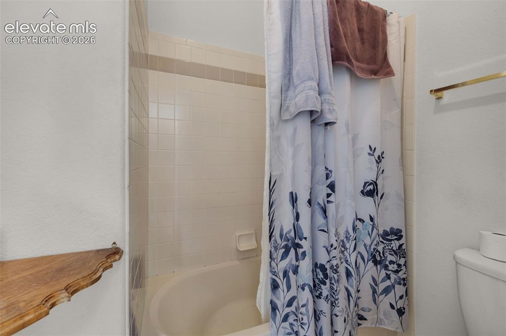 Image 33 of 48: Upstairs Full Bath with Double Vanity and Skylight