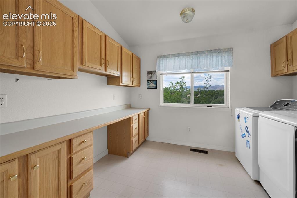 Image 34 of 48: Laundry Room with Plenty of Cabinet Space