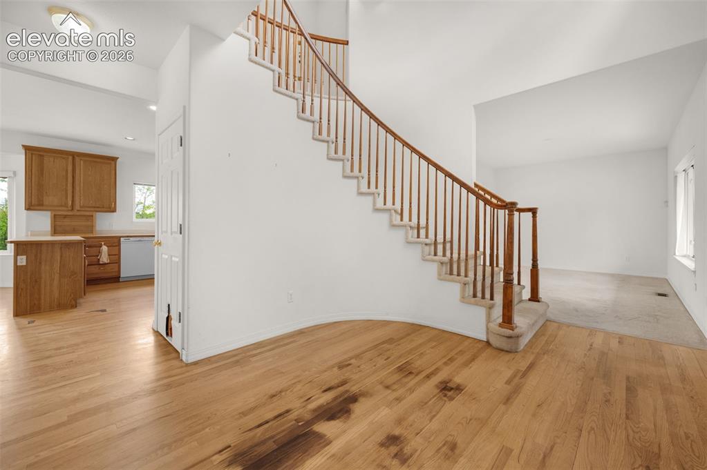 Image 6 of 48: Entrance Foyer Featuring Soaring Ceiling, Curved Staircase and Harwood Floo