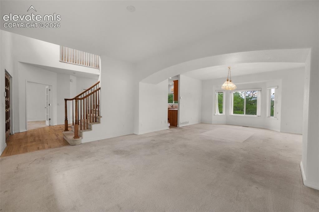 Image 9 of 48: Viewing the Entry Foyer and Dining Room from the Living Room