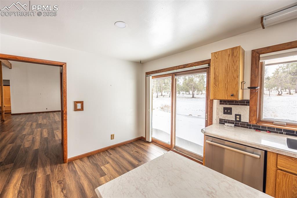 Image 13 of 36: Kitchen featuring stainless steel dishwasher, light countertops, tasteful b