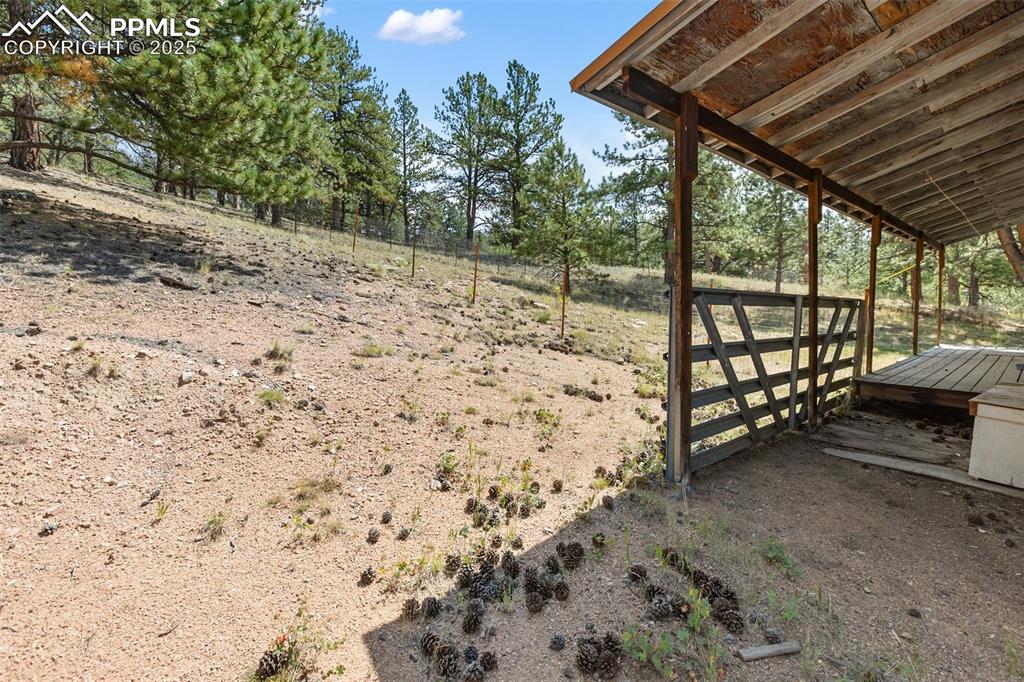 Image 26 of 41: Fenced back yard and covered back porch. 