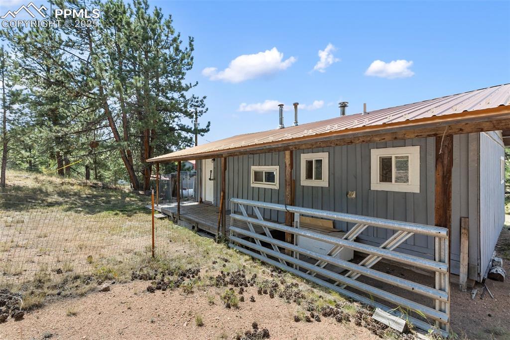 Image 27 of 41: Back porch with enclosed fence for your pets to run. 
