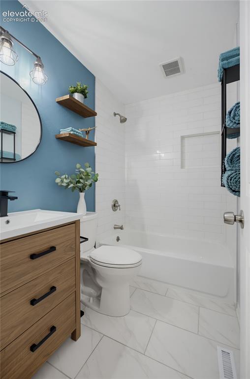 Image 14 of 29: Wood-finish vanity with black hardware, white rectangular sink, and matte b