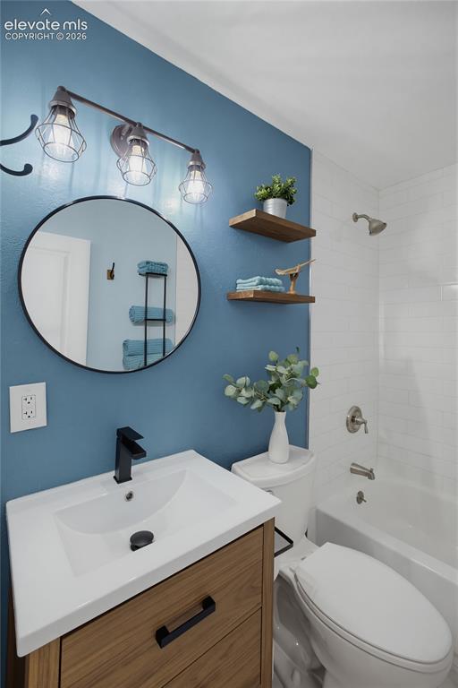Image 15 of 29: Vanity with integrated sink, black-finish faucet, and wood-finish cabinetry