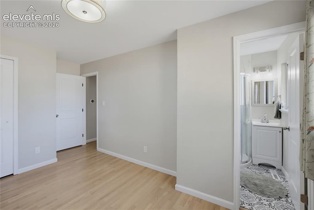 Image 18 of 29: Light wood-finish flooring with neutral wall tones