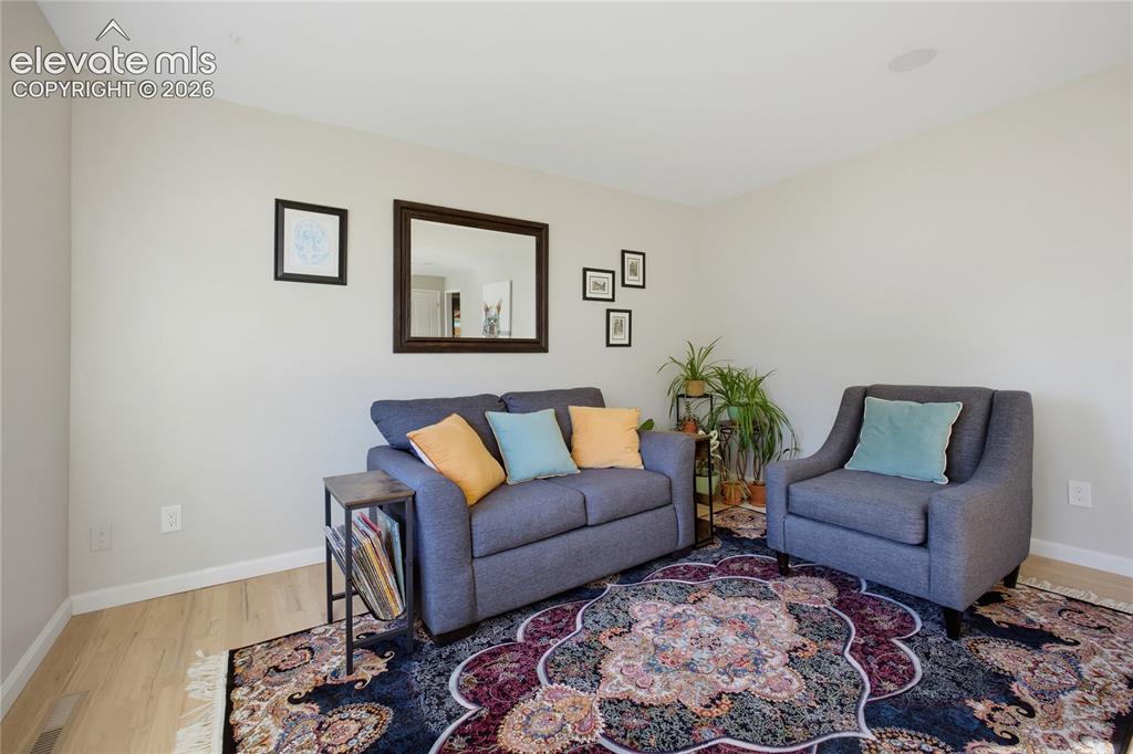 Image 4 of 29: Light-toned wall paint with wood-finish flooring