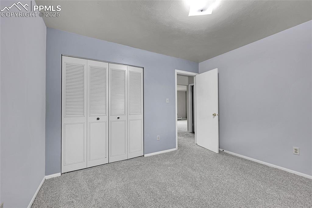 Image 29 of 33: Unfurnished bedroom featuring carpet and a closet