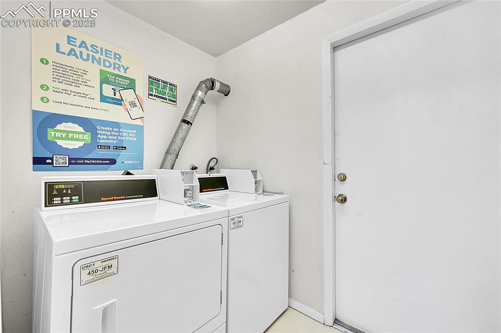 Image 33 of 33: Community laundry featuring washing machine and clothes dryer