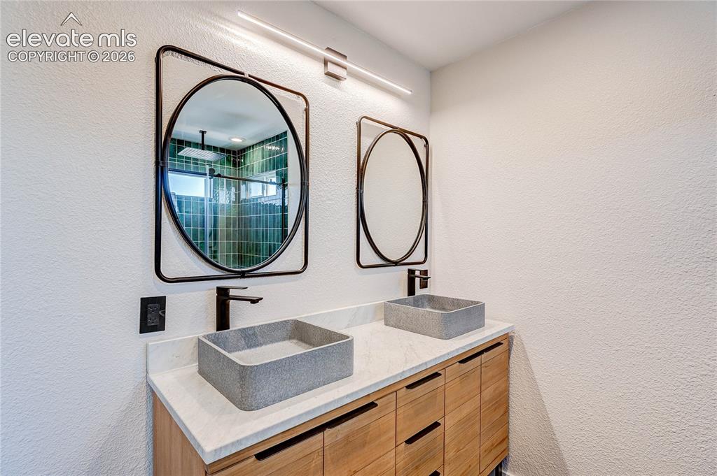 Image 18 of 42: Walk-in closet and remodeled private bath with barn door.