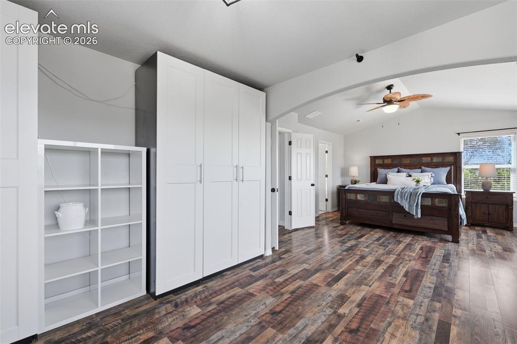 Image 27 of 49: Another view of the master suite with plank flooring and double doors!