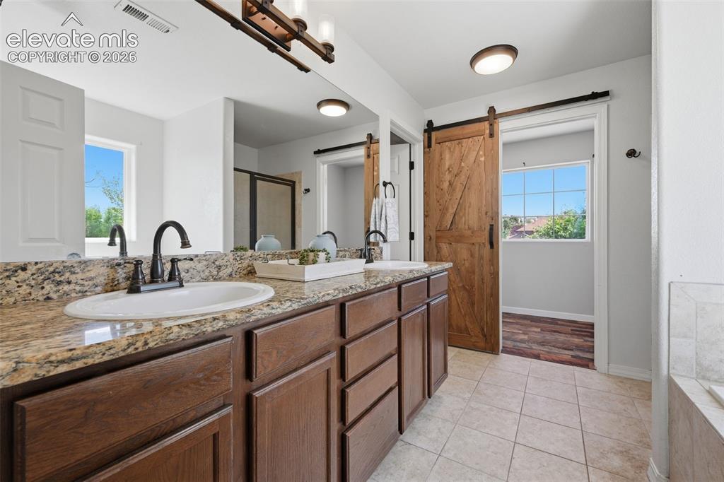 Image 30 of 49: Granite counters in the spacious master bath!