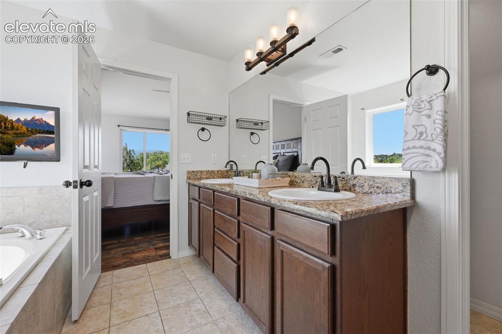 Image 31 of 49: Spa like master bath retreat with granite counters!