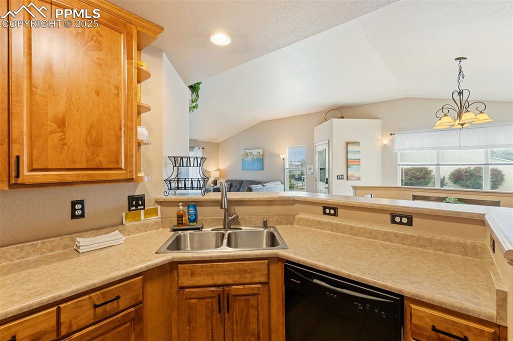 Image 10 of 27: Kitchen featuring dishwasher, open floor plan, open shelves, light countert