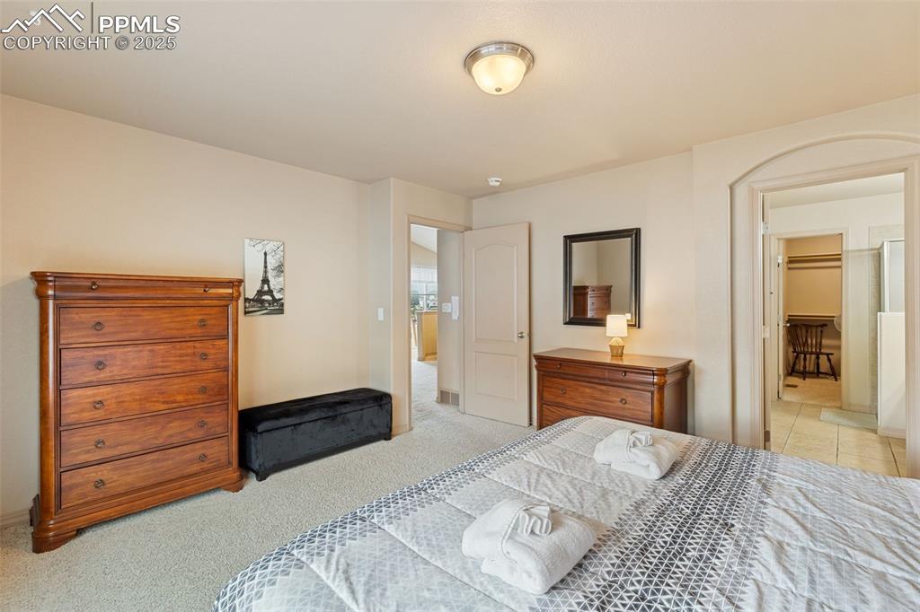 Image 11 of 27: Bedroom featuring light colored carpet