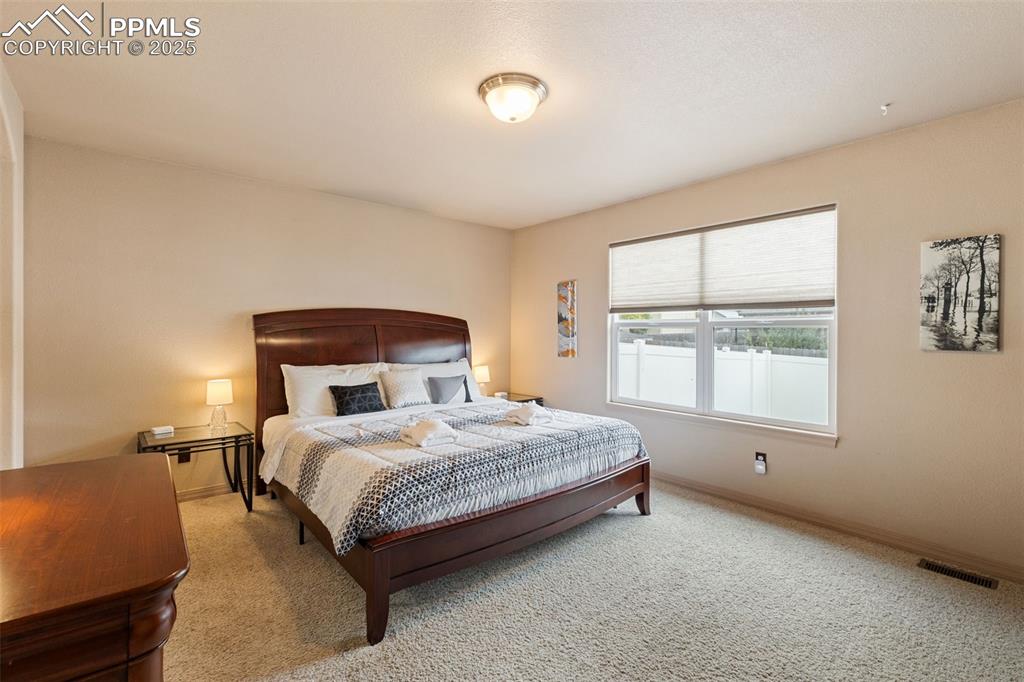Image 13 of 27: Bedroom with carpet and baseboards