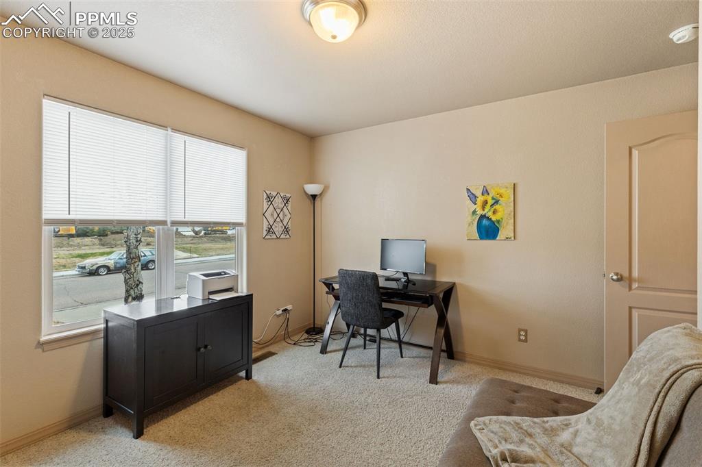 Image 14 of 27: Office space featuring light carpet and baseboards