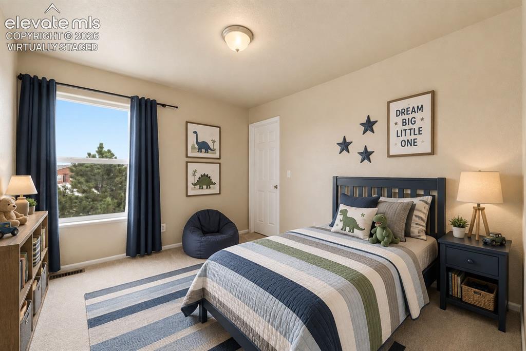 Image 12 of 33: *Virtually Staged*
Carpeted room featuring a single window with dark drape