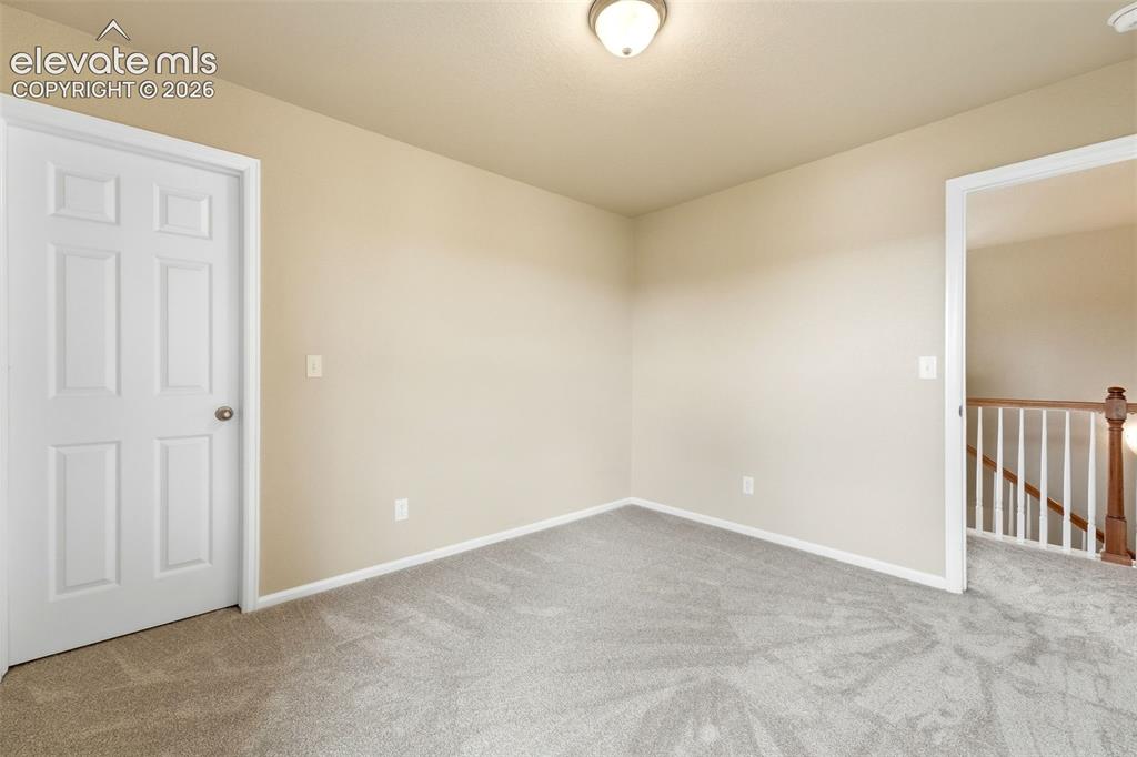 Image 16 of 33: Neutral wall tones, ceiling-mounted light fixture, white interior door, lig