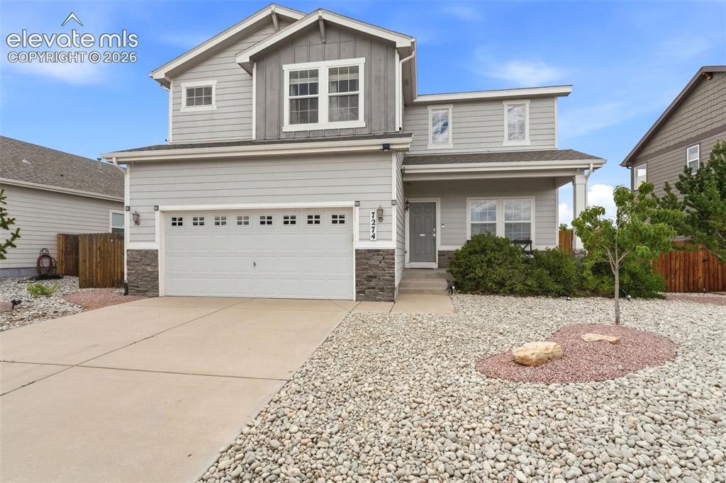 Image 2 of 33: Xeriscaped Front Yard, covered porch entry, and low-maintenance xeriscape l