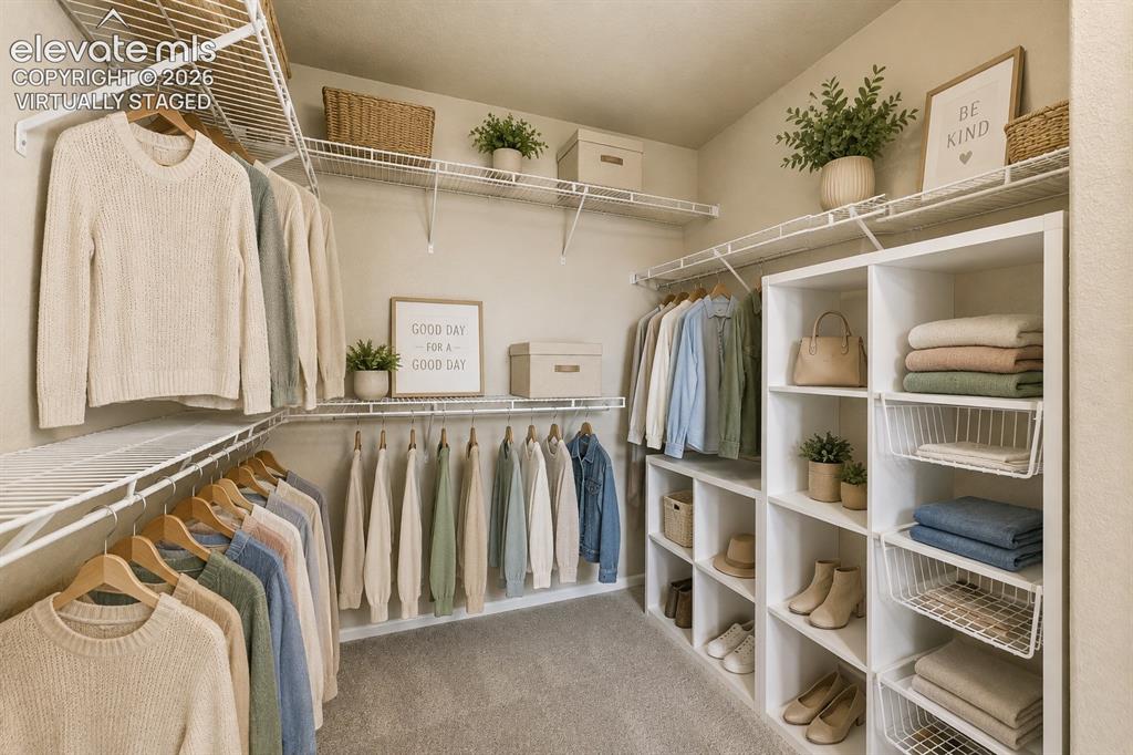 Image 21 of 33: *Virtually Staged*
Built-in shelving with wire racks, wire hanging rods, i