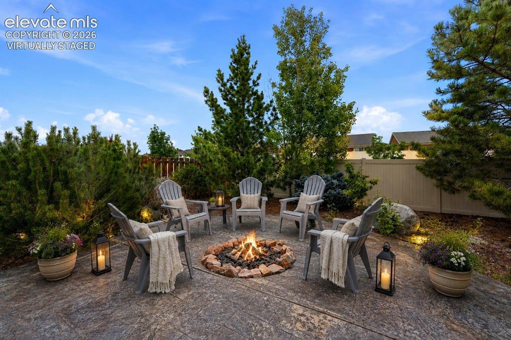 Image 26 of 33: *Virtually Staged*
Stamped Concrete patio with a built-in fire pit, surrou