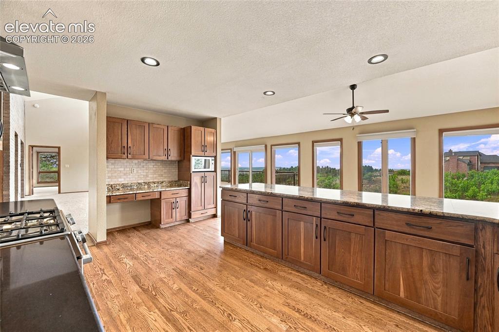 Image 11 of 50: kitchen with lots of counter top space and cabinetry