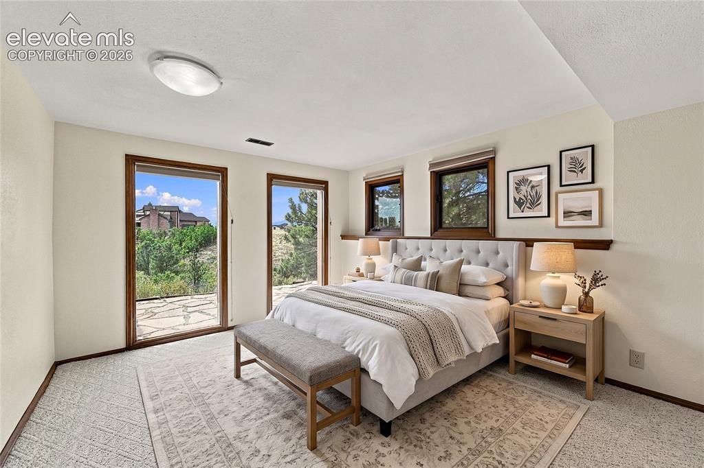 Image 40 of 50: bonus room in basement/staged as bedroom with adjoining bathroom
