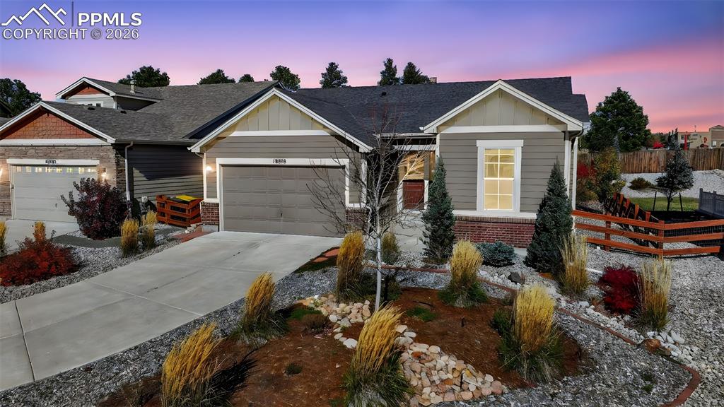 Caption: Beautiful ranch-style home with rear fence and landscaping 