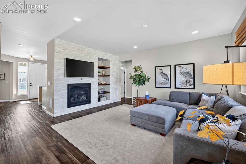 Image 10 of 32: living room with gas fireplace and stacked stone