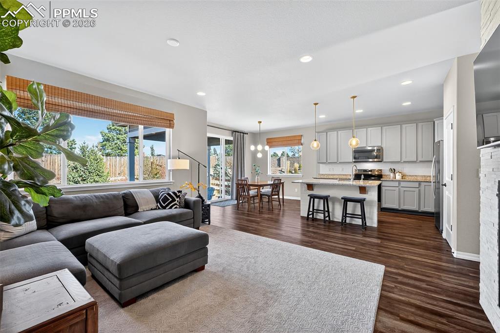 Image 11 of 32: open and flowing floor plan with dining, living, and kitchen