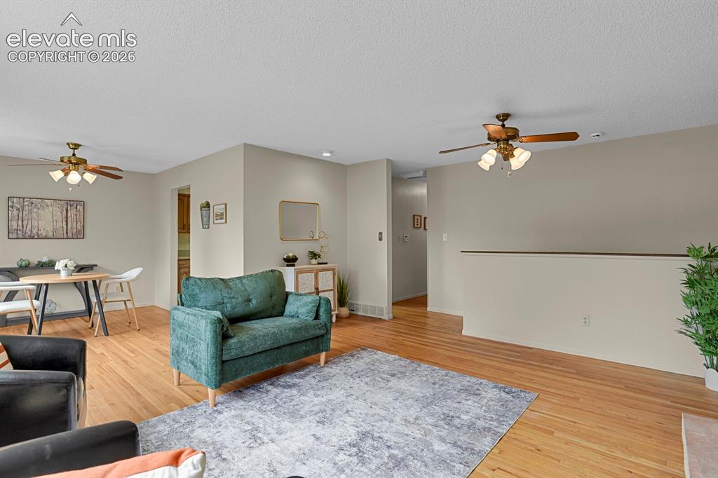 Image 11 of 48: Hardwood-style flooring throughout, ceiling fans with integrated lighting,