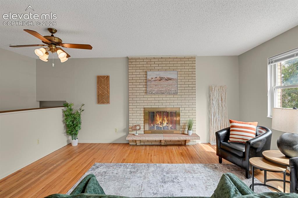Image 12 of 48: Wood-finish flooring throughout, ceiling fan with integrated lighting, a li