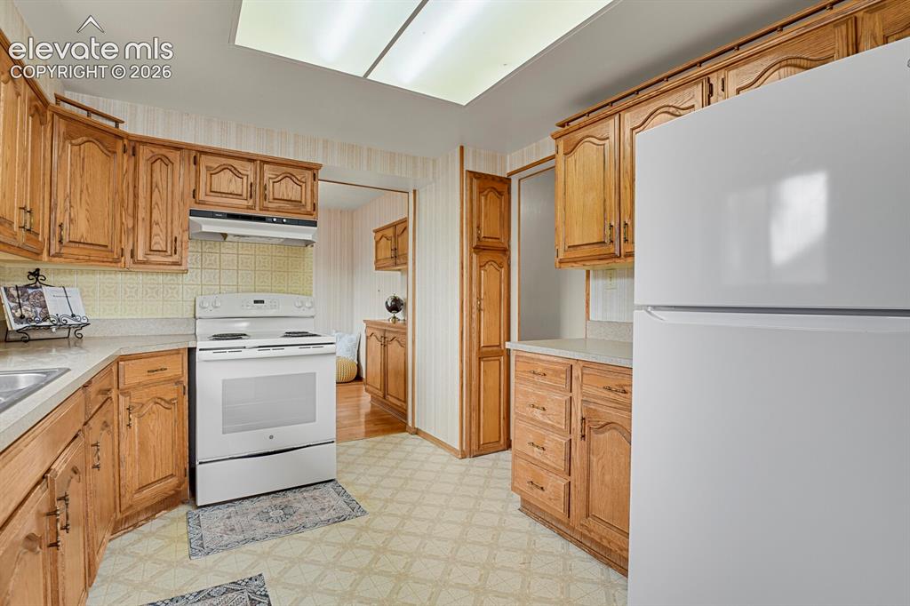 Image 16 of 48: Kitchen featuring wood-finish cabinetry