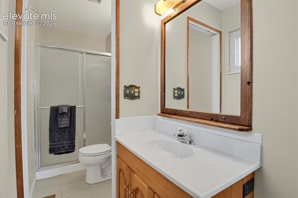 Image 24 of 48: Separate sink/vanity; free standing shower and toilet 