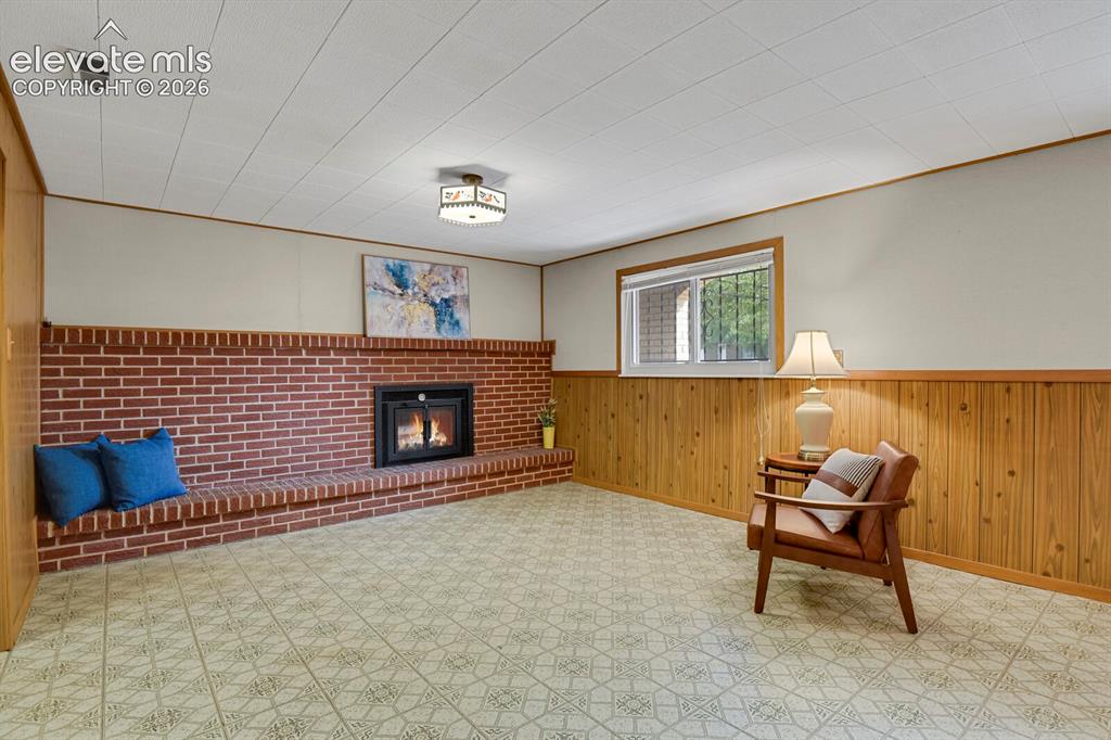 Image 29 of 48: Brick fireplace with a raised hearth