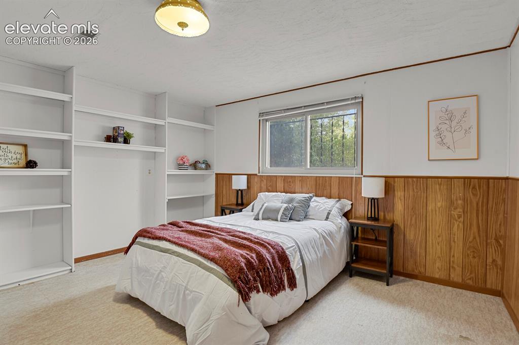 Image 33 of 48: Basement Bedroom with Built-in shelving