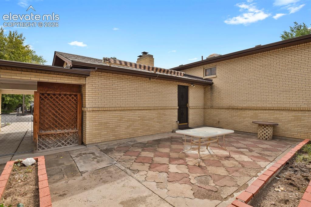 Image 42 of 48: Patio with a retractable awning